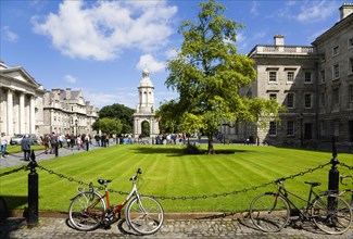 Ireland, County Dublin, Dublin City, Trinity College university with people walking through