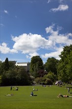 Ireland, North, Belfast, Botanic Gardens with people relaxing in the sun.