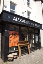 Ireland, North, Belfast, Donegall Pass, Alexander the Grate fireplace shop with sign displayin 50%