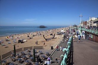 England, East Sussex, Brighton, view over tables outside seafront bar under the promenade.