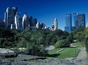 New York City, New York, USA. Central Park with city skyline of 5th Avenue beyond American Blue