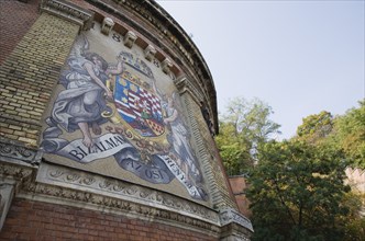 Budapest, Pest County, Hungary. Mural depicting coat of arms at entrance to Siklo Funicular.