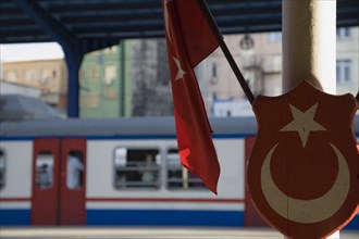 Istanbul, Turkey. Sultanahmet. Istanbul Sirkeci Terminal Turkish flag and emblem in foreground with