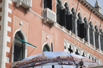 Venice, Veneto, Italy. Open umbrella printed with painting Return of the Bucentoro to the Molo on