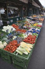 Vienna, Austria. The Naschmarkt. Display of fresh fruit and vegetables in front of shopfronts.
