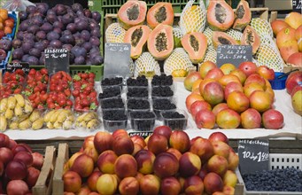 Vienna, Austria. Display of fresh fruit for sale on market stall including plums strawberries