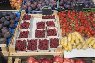Vienna, Austria. Display of fresh fruit for sale on market stall including figs raspberries