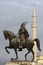 Tirana, Albania. Statue of Skanderbeg the national hero with the Ethem Bey mosque in the background