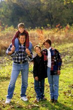 Children with parents in beautiful Fall color setting. Adult Adults Affection Affectionate Arm