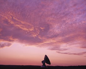 Bavaria, Germany, Communications. Satellite dish against pink and purple sunset sky. Germany German