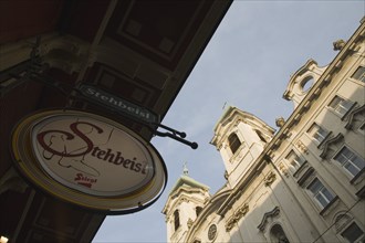 Vienna, Austria. Circular bar sign with Empire era building facade behind. Austria Austrian