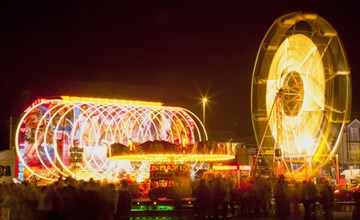 Lancing, West Sussex, England. Entertainment Funfairs Rides illuminated at night. England English