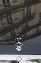 Vienna, Austria. Building facade reflected in bonnet of Mercedes car. Austria Austrian Republic
