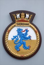 HMS Shoreham emblem on board the mine sweeper. Sign Signs Emblem Coat Arms Military Naval Royal