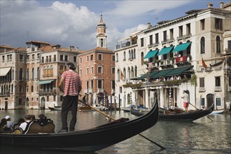 Venice, Veneto, Italy. Gondolier manoeuvres gondola before start of Regata Storico the Venice