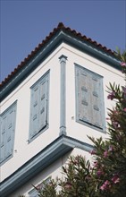 Samos Island, Northern Aegean, Greece. Vathy. Part view of house facade with tiled roof and blue