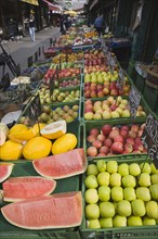 Vienna, Austria. The Naschmarkt. Display of melon and apples for sale on fresh fruit stall in