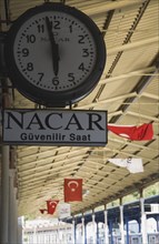 Istanbul, Turkey. Sultanahmet. Station clock giving time of three minutes to six on platform with