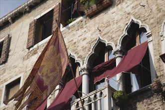 Venice, Veneto, Italy. Centro Storico Flag of the Republic of Venice depicting winged lion flies