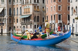 Venice, Veneto, Italy. Participants in the Regata Storico annual historical regatta in brightly