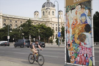 Vienna, Austria. Neubau District. Cyclist on Ringstrasse passing poster for the Leopold Museum