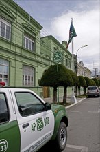 Punta Arenas, Magellan and Antarctic Region, Chile. Green painted Police Headquarters off the Plaza