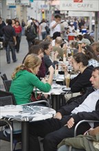 Vienna, Austria. Mariahilf District. Customers at line of busy outside cafe tables. Austria