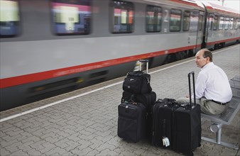 Vienna, Austria. Wien Westbahnhof. Passenger with luggage sitting on Vienna West Station with