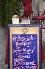 Vienna, Austria. A board sign outside courtyard cafe advertising breakfast menu. Austria Austrian