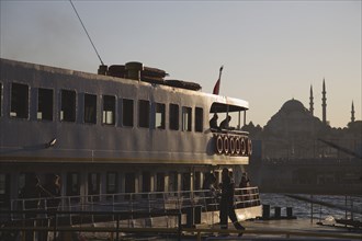 Istanbul, Turkey. Sultanahmet. Bosphorous passenger ferry at sunset with Hagia Sophia behind.
