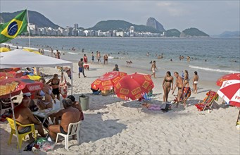 Rio de Janeiro, Brazil. Copacabana beach and Sugarloaf Mountain. Beach umbrellas swimers in sea