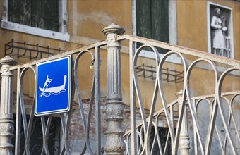 Venice, Veneto, Italy. Centro Storico Gondola access via iron stairway indicated with tourist sign