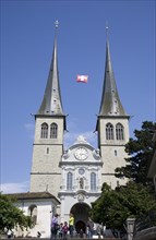 Lucerne, Switzerland. St Leodegar Church exterior with tourists. Switzerland Swiss Lucerne Lucerna