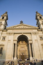 Budapest, Pest County, Hungary. Exterior facade of Saint Stephens Basilica with crowd of visitors