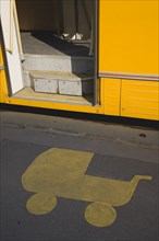 Budapest, Pest County, Hungary. Painted marking on pavement at tram stop depicting pram with open