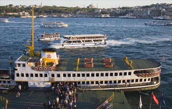 Istanbul, Turkey. Sultanahmet. People boarding Bosphorous passenger ferry at sunset with Hagia