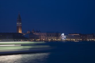 Venice, Veneto, Italy. Giudecca island Early evening view towards illuminated Campanile of St. Mark