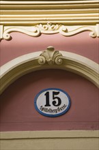 Vienna, Austria. Detail of pink and cream painted exterior facade with street number 15. Austria