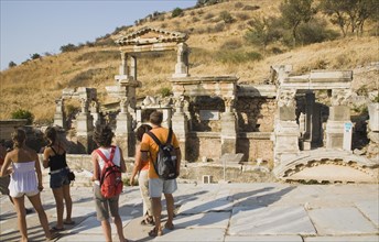 Selcuk, Izmir Province, Turkey. Ephesus. Tourists stopped to look at ruined stonework in ancient