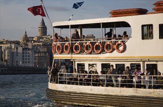 Istanbul, Turkey. Sultanahmet. Crowded passenger ferry flying Turkish flag on the Bosphorous with