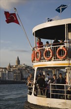 Istanbul, Turkey. Sultanahmet. Crowded passenger ferry flying Turkish flag on the Bosphorous with