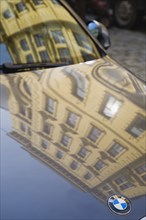 Vienna, Austria. Building facade reflected in bonnet and windscreen of BMW car. Austria Austrian