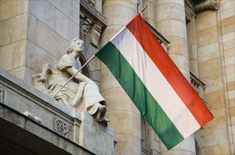 Budapest, Pest County, Hungary. Hungarian flag flying from building facade. Hungary Hungarian