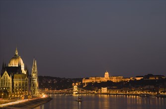 Budapest, Hungary. View along the River Danube at night with the Parliament building on the left