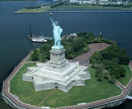 New York, New York State, USA. Statue of Liberty. Star shaped plinth river with moored island ferry