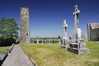 Clonmacnoise, County Offaly, Ireland. Monastery Round tower with row of crosses and River Shannon