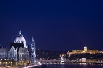 Budapest, Hungary. View along the River Danube at night with the Parliament building on the left