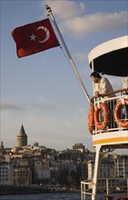 Istanbul, Turkey. Sultanahmet. Part view of passenger ferry flying Turkish flag with man leaning on