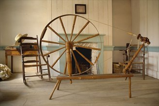 Omagh, County Tyrone, Ireland. Ulster American Folk Park Spinning wheel in Pennsylvania Log