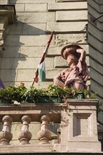 Budapest, Pest County, Hungary. Art Nouveau exterior facade with rolled Hungarian flag flower pots